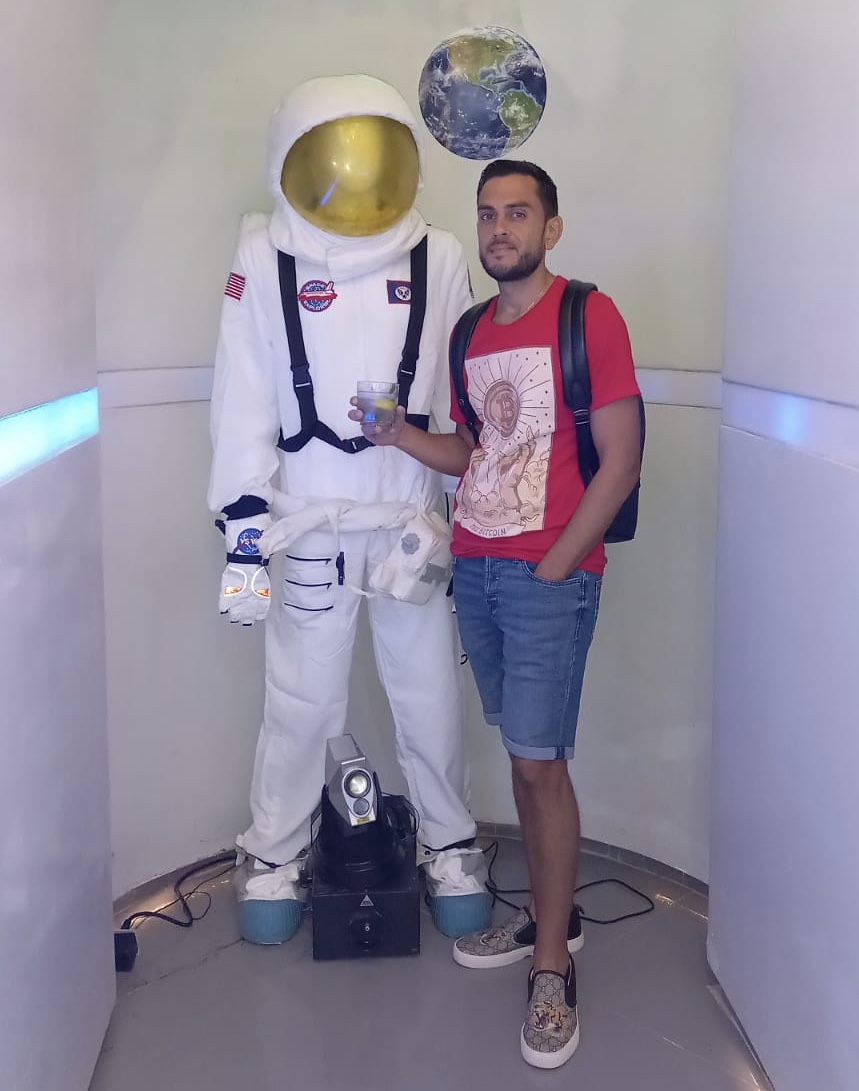 Sean Ali standing with a robot as a symbol of AI leverage